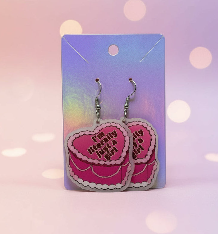 Heart-shaped earrings on a purple card with a pink heart background