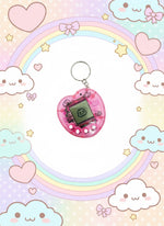 Mini electronic fidget keychain toy in pink shape with nostalgic screen and buttons on a colorful background.