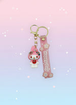 Pink keychain with a cartoon character on a white background