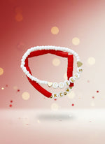 Handmade bead bracelets featuring red and white beads with heart and letter charms, perfect for game day.