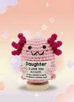 Emotional Support Axolotl by Craft-N-Crumble, a cute crochet axolotl with a sign for encouragement and love.