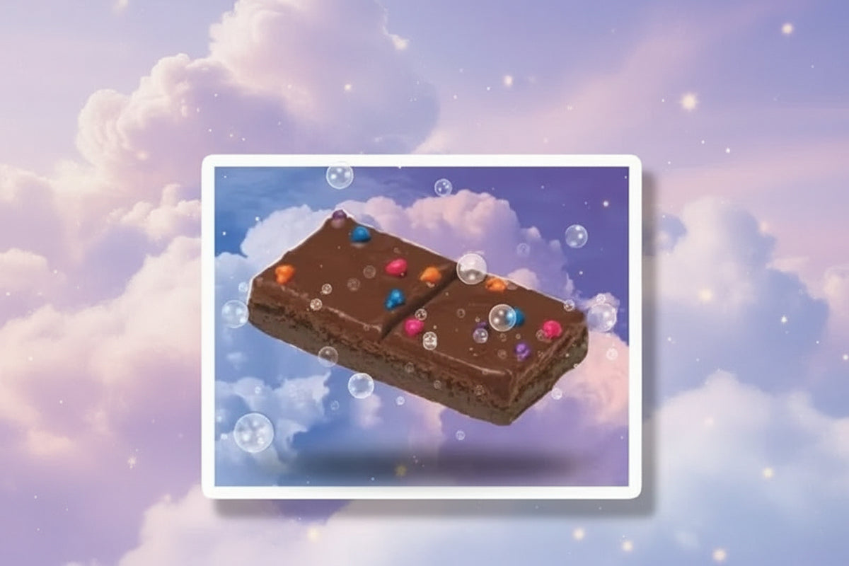 Cosmic brownie space sticker featuring a brownie with colorful sprinkles floating in a dreamy cloud background.