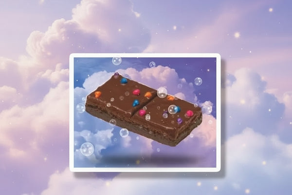 Cosmic brownie space sticker featuring a brownie with colorful sprinkles floating in a dreamy cloud background.