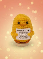 Emotional support duck plushie with a sign reading 'You're Ducking Awesome!' for encouragement and joy.