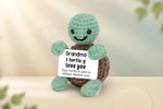 Emotional Support Turtle holding a sign that says 'Grandma I turtle-y love you' for sentimental moments.