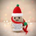 Emotional support crochet christmas potato with wooden stand holding a sign that reads 'Positive potato'.
