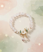 Floral crystal beaded bracelet featuring sparkling beads and floral accents on a soft watercolor background.