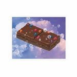 Cosmic brownie space sticker featuring a brownie floating in space with colorful sprinkles and bubbles.