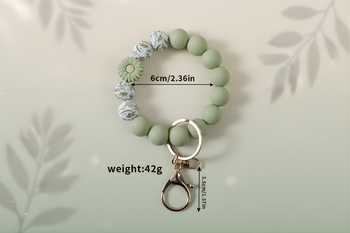 Silicone Wristlet Keychain in green with decorative beads, 6cm size, 42g weight, perfect gift accessory.