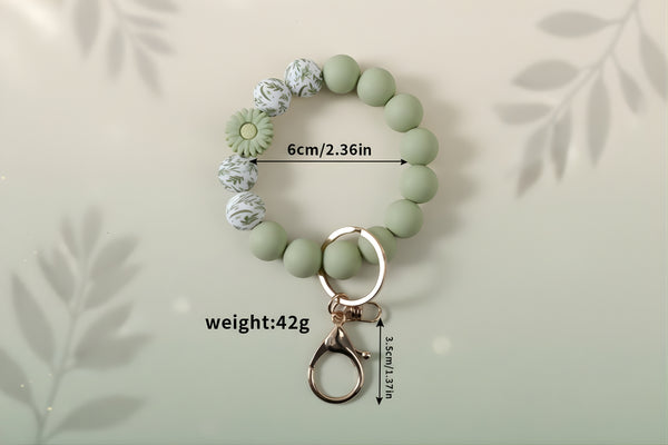 Silicone Wristlet Keychain in green with decorative beads, 6cm size, 42g weight, perfect gift accessory.