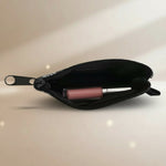 Interior view of a sardines coin purse with a lip gloss inside, showcasing its compact design.