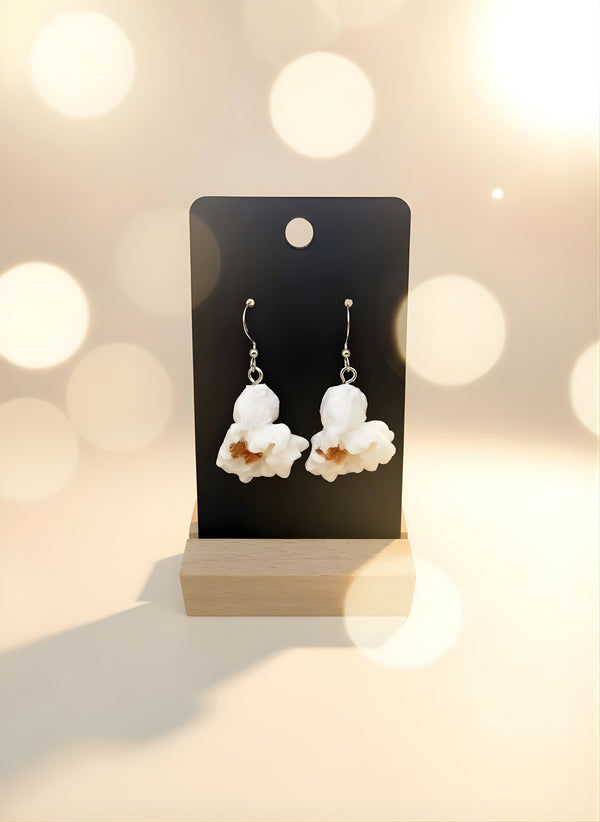 Popcorn Earrings displayed on a stand, featuring playful popcorn shape design for whimsical food jewelry.
