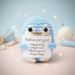 Positive Penguin Crochet Plush with Wooden Stand holding a motivational sign that inspires positivity and encouragement.