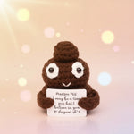 Positive Poo Crochet Doll with Wooden Stand holding a motivational card with a cute expression.