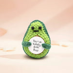 Positive Avocado Crochet Plush with Wooden Stand holding a sign that says 'You’ve Totally Guac This'.