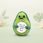Positive Avocado Crochet Plush with Wooden Stand holding a sign that says 'You’ve Totally Guac This'.