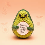 Positive Avocado Crochet Plush with Wooden Stand holding a sign that says ‘You’ve Totally Guac This’.