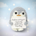 Positive Penguin Crochet Plush with Wooden Stand encouraging desk buddy holding a motivational sign.