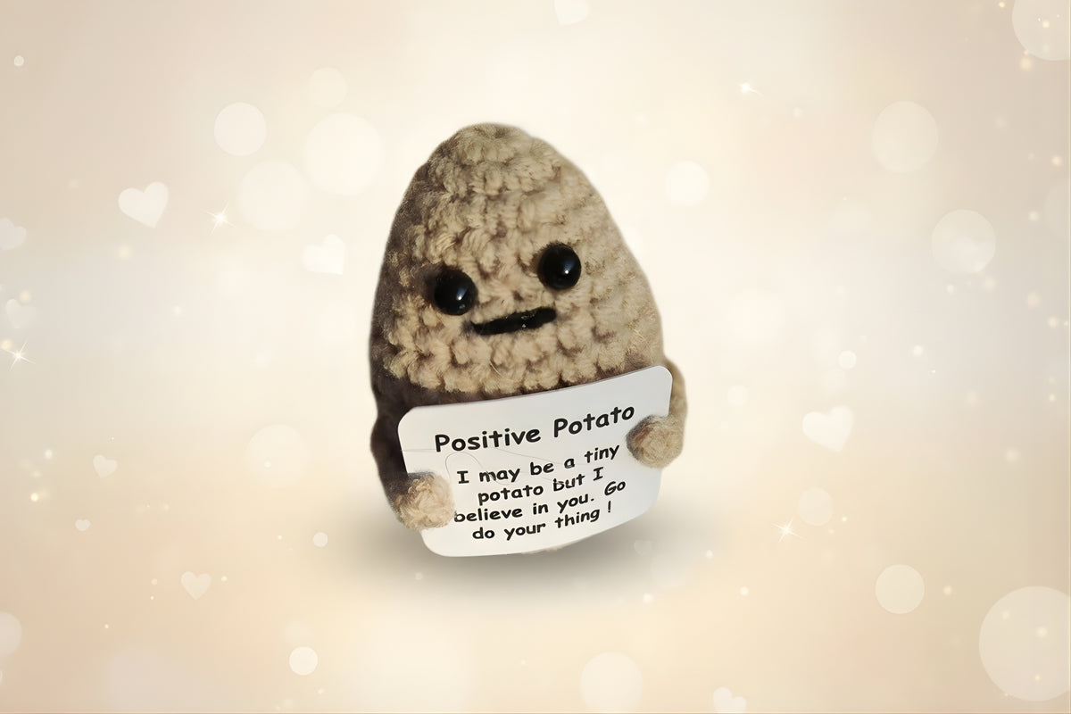 Emotional support potato plushie with a sign that says 'Positive Potato' encouraging positivity and comfort.