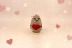 Adorable Emotional Support Potato plushie holding a red heart, handmade with soft yarn, surrounded by hearts.