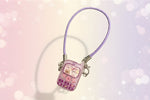 Miniature doll cell phone with purple strap featuring a cute character design, perfect for monster dolls.