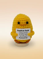 Emotional support duck plushie with sign promoting positivity and encouragement in a cheerful yellow color.