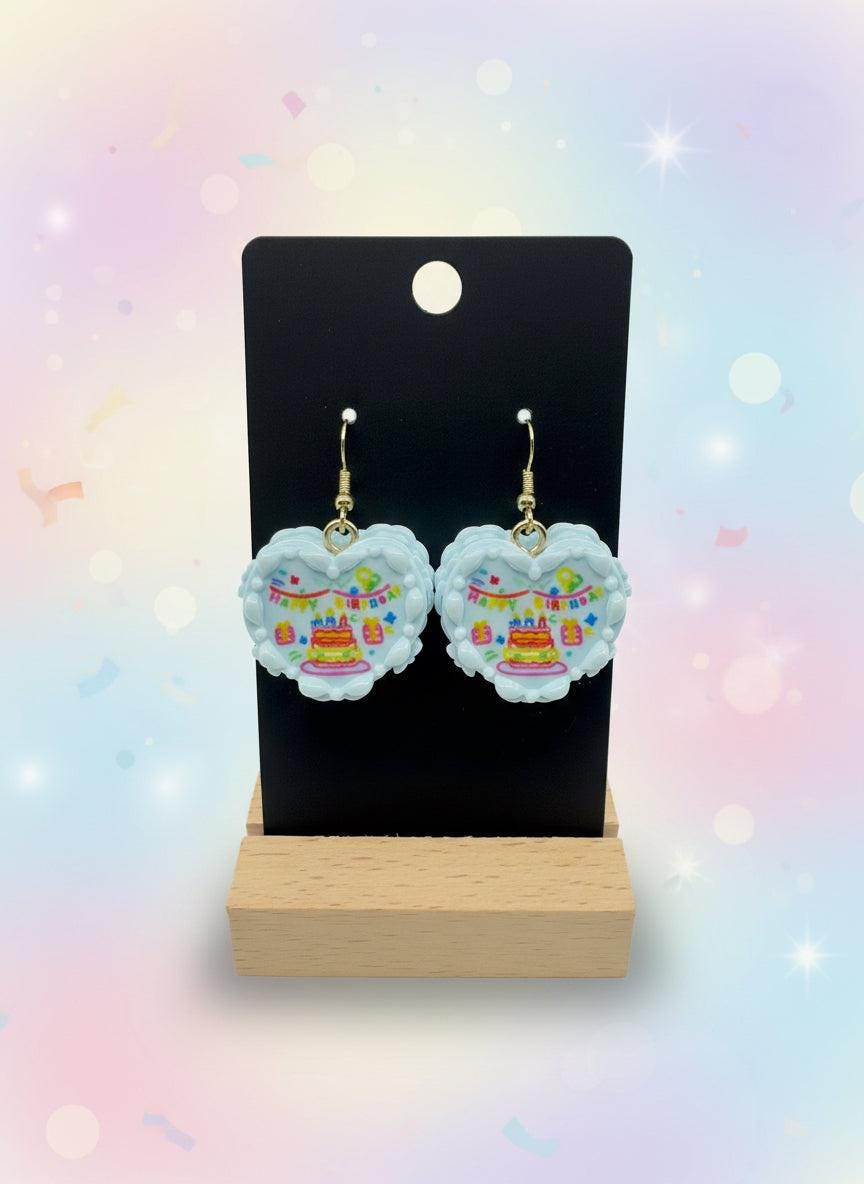 Mini Resin Cake Earrings – Handmade dessert jewelry with colorful cake design on a display.