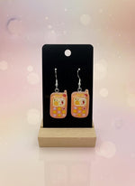 Adorable Kawaii Phone Earrings displayed on a wood stand, showcasing cute resin cartoon phone design in pastel colors.