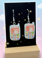 Adorable Kawaii Phone Earrings featuring cute cartoon phone designs with colorful characters and glossy resin finish.