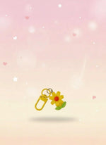 Floral keychain in clear packaging with 'Sweetie' label on red backing