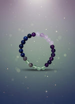 Multicolored beaded bracelet on a white background with a brown cardboard holder.