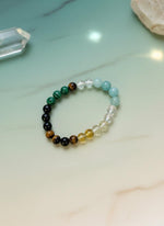 Multicolored beaded bracelet on a cardboard card against a white background