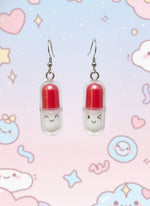 Pair of earrings on a black card with a white background