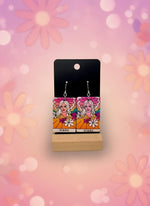 Earrings on a display card with a white background