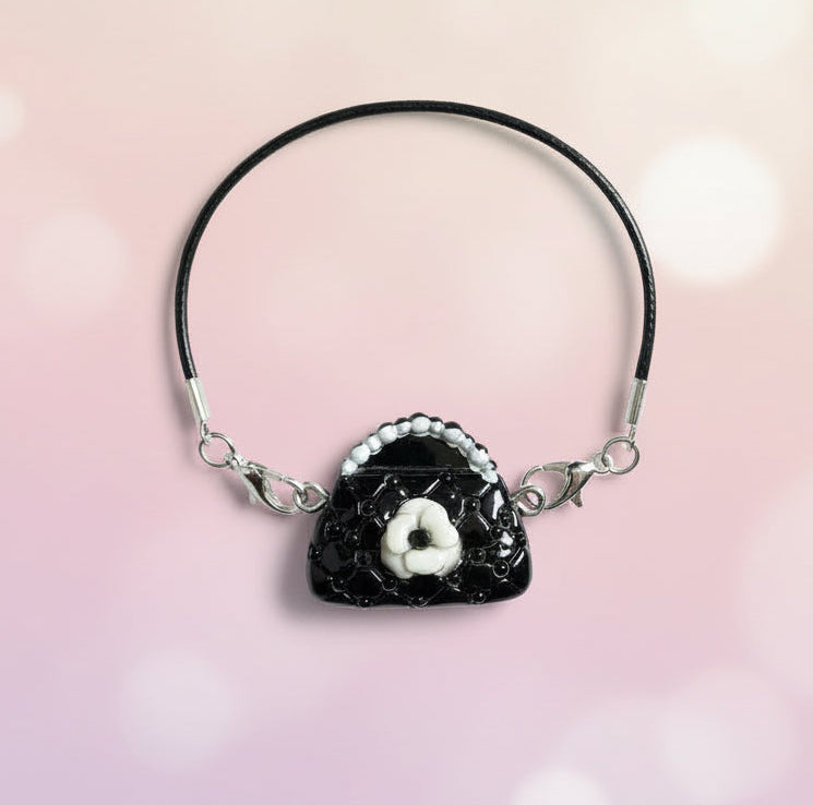 Necklace with a black and white pendant on a wooden surface