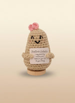 Emotional support potato plushie with a smile and sign saying 'Positive Potato' for encouragement and comfort.