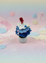 Mini Crochet Christmas Tree Ornament displayed in a cute pot, showcasing its handmade design and charming details.