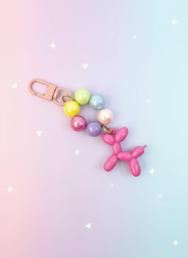 Keychain with colorful beads and pink balloon dog charm on a white background