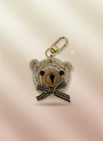 Crocheted bear keychain with a bow