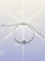 Yellow beaded bracelet on a white background with a brown card