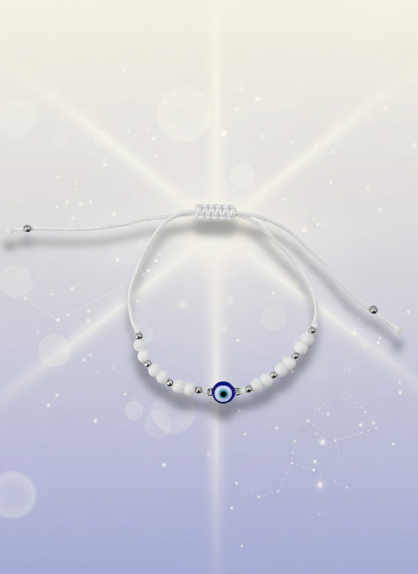 Yellow beaded bracelet on a white background with a brown card