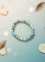 Beaded bracelet on a white background with a brown cardboard holder