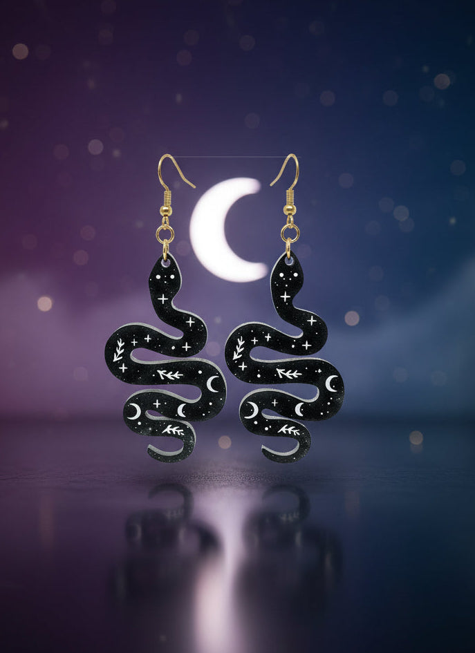 Black and gold jewelry set on a display card against a white background