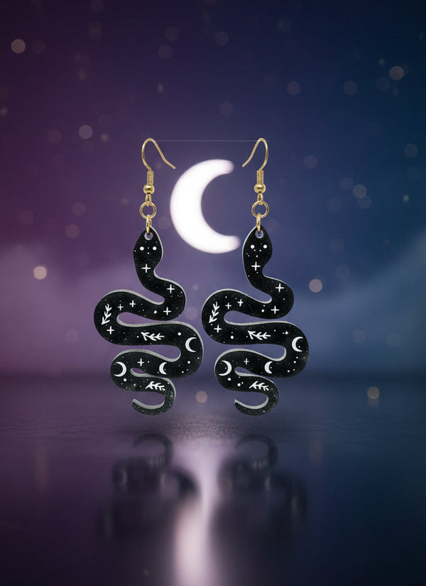 Black and gold jewelry set on a display card against a white background