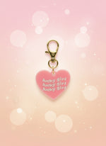 Pink heart-shaped object with 'lucky girl' text on a yellow stick, against a marble background.