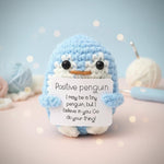 Positive Penguin Crochet Plush with Wooden Stand holding a motivational sign that inspires positivity and encouragement.