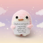 Positive Penguin Crochet Plush with Wooden Stand holding a sign with an encouraging message.
