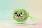 Plush animal coin pouch in green with cute smiley face and zipper for storing small items.